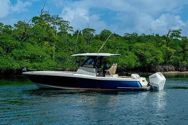  Yacht Photos Pics 2019 Chris-Craft Catalina 30 boat on calm water near lush green mangroves.