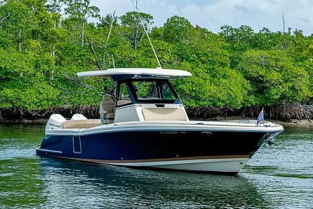 Yacht Photos Pics 2019 Chris-Craft Catalina 30 boat cruising near lush green mangroves.