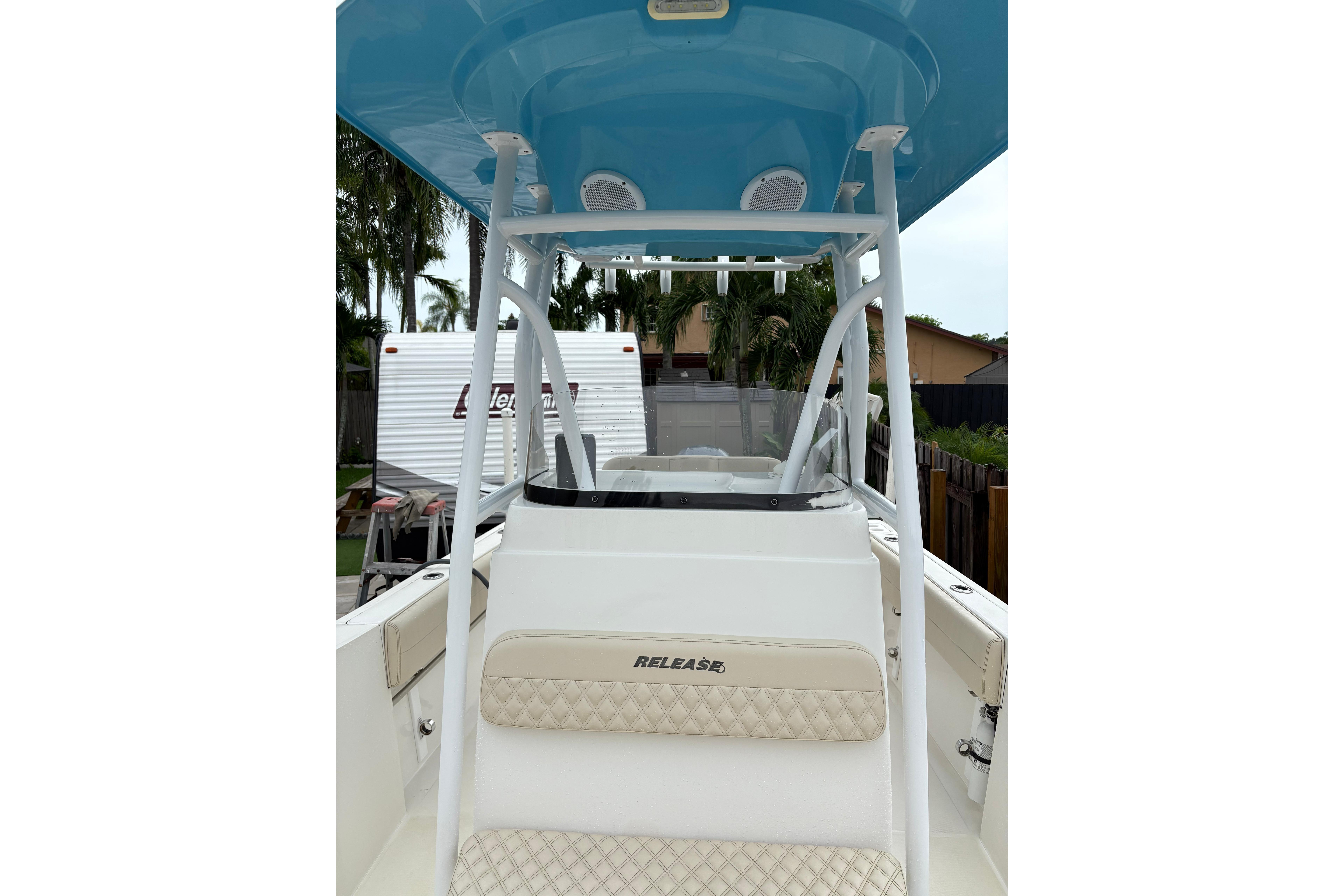 2019 Release 210 RX boat with blue canopy and beige seating.