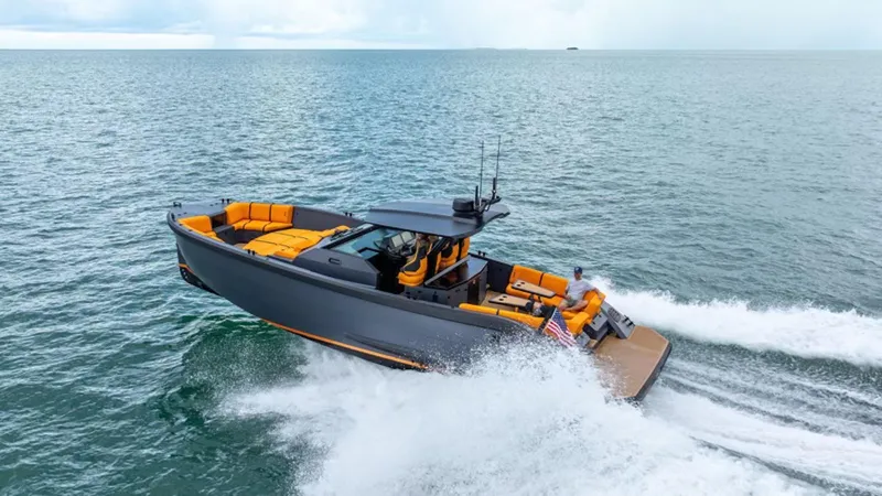  Yacht Photos Pics 2024 Lekker 44 boat cruising on open water with vibrant orange seating.