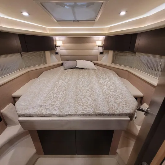  Yacht Photos Pics Luxurious interior of 2016 Cranchi Z35 yacht with elegant bedding and ambient lighting.