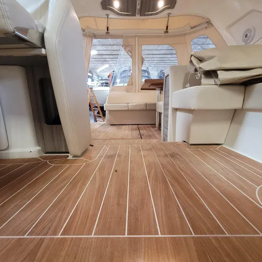  Yacht Photos Pics Interior of 2016 Cranchi Z35 yacht with wooden flooring and beige seating.
