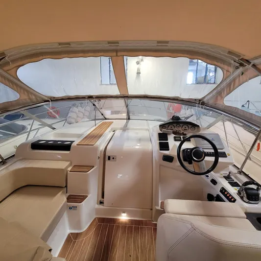  Yacht Photos Pics Interior view of 2016 Cranchi Z35 yacht cockpit with steering wheel and seating.