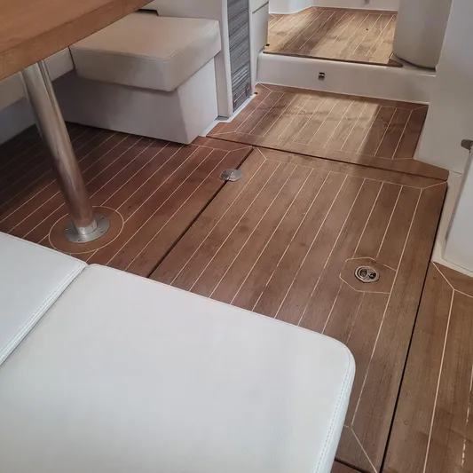  Yacht Photos Pics 2016 Cranchi Z35 interior with wooden flooring and white seating.