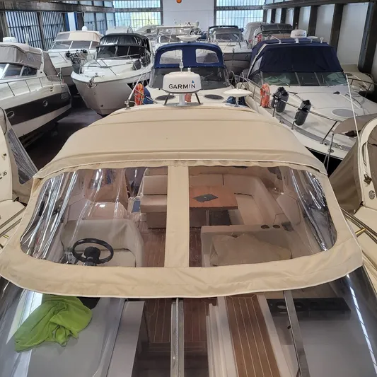  Yacht Photos Pics 2016 Cranchi Z35 yacht in storage, surrounded by other boats, featuring a beige canopy.
