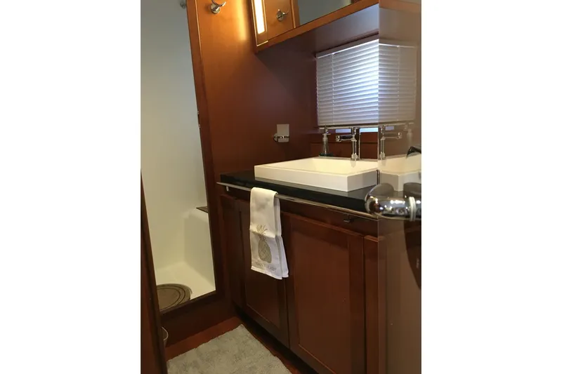  Yacht Photos Pics 2018 Beneteau Swift Trawler 50 bathroom with wooden cabinetry and modern sink.