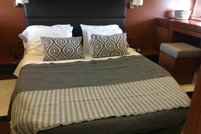  Yacht Photos Pics Luxurious bedroom interior of 2018 Beneteau Swift Trawler 50 with elegant bedding and decor.