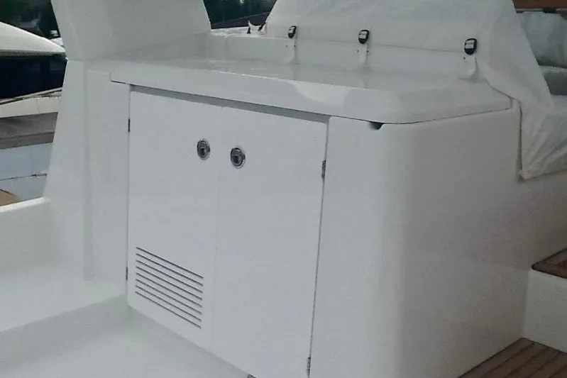  Yacht Photos Pics 2018 Beneteau Swift Trawler 50 deck with storage compartment and seating area.