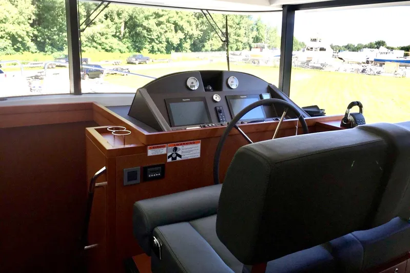  Yacht Photos Pics 2018 Beneteau Swift Trawler 50 helm with modern controls and panoramic view.