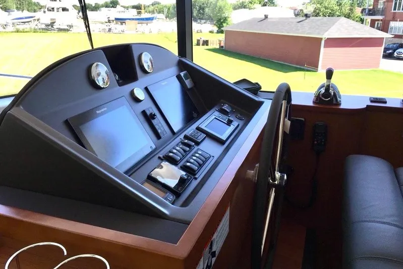  Yacht Photos Pics Helm of 2018 Beneteau Swift Trawler 50 with navigation controls and steering wheel.