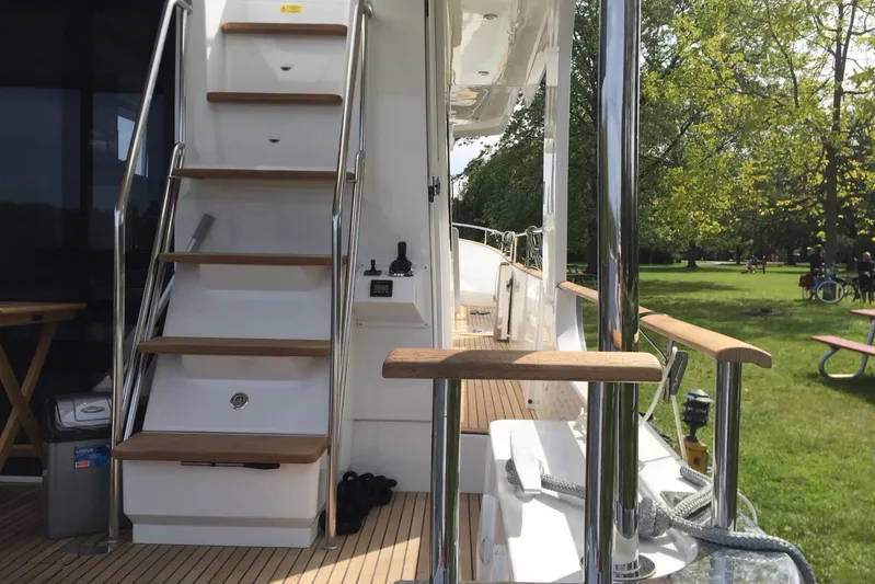  Yacht Photos Pics 2018 Beneteau Swift Trawler 50, featuring elegant wooden stairs and polished railings.