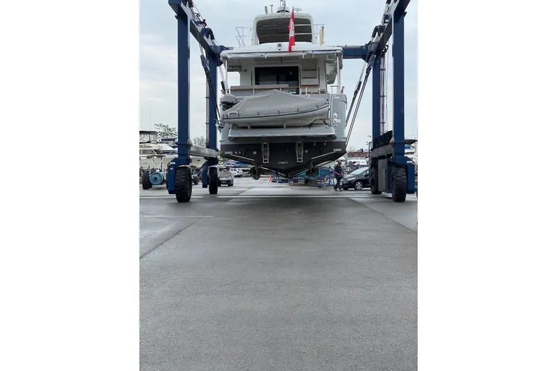  Yacht Photos Pics 2018 Beneteau Swift Trawler 50 being lifted in a boatyard.