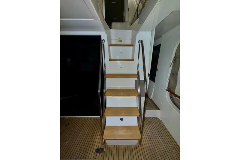  Yacht Photos Pics Staircase on 2018 Beneteau Swift Trawler 50 with wooden steps and metal railings.