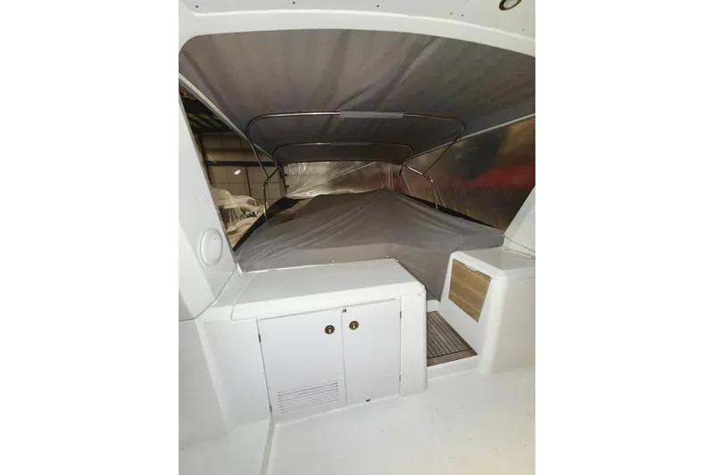 Yacht Photos Pics 2018 Beneteau Swift Trawler 50 interior with covered seating area and storage.
