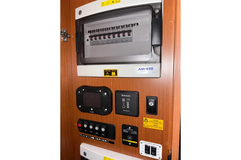  Yacht Photos Pics Electrical panel of 2018 Beneteau Swift Trawler 50 with control switches and warning labels.