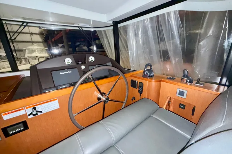  Yacht Photos Pics 2018 Beneteau Swift Trawler 50 helm with Raymarine navigation system and leather seating.