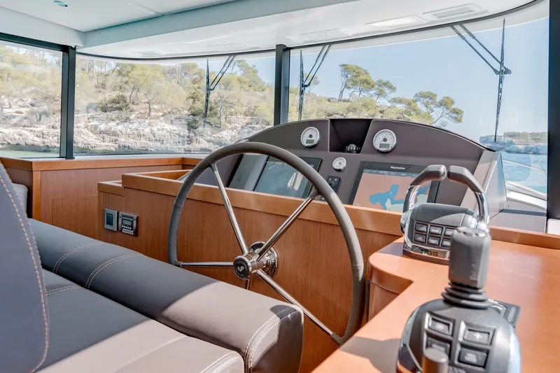  Yacht Photos Pics 2018 Beneteau Swift Trawler 50 helm with modern navigation controls and panoramic view.
