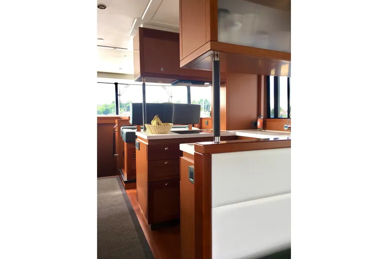  Yacht Photos Pics Interior of 2018 Beneteau Swift Trawler 50, featuring modern wood cabinetry and seating.