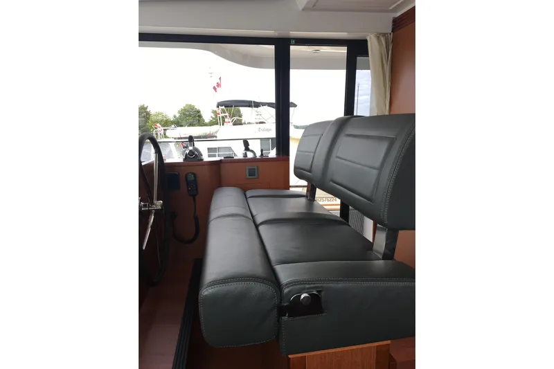  Yacht Photos Pics Interior of 2018 Beneteau Swift Trawler 50 with leather seating and helm station.