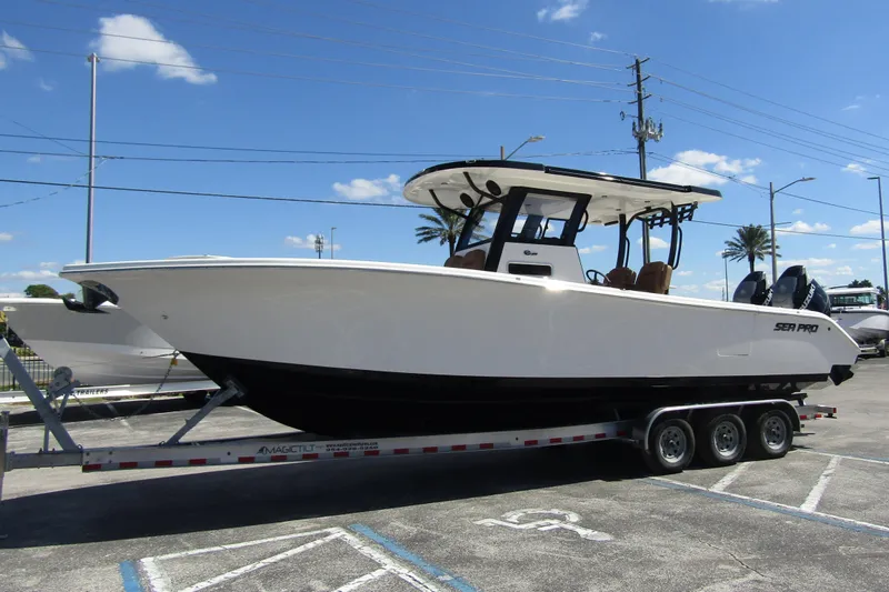  Yacht Photos Pics 2025 Sea Pro 322 Offshore boat on trailer under clear blue sky.