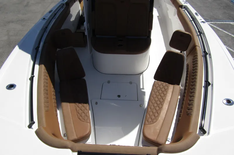  Yacht Photos Pics 2025 Sea Pro 322 Offshore boat interior with brown cushioned seating and sleek design.