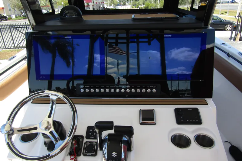  Yacht Photos Pics 2025 Sea Pro 322 Offshore boat dashboard with steering wheel and navigation screens.
