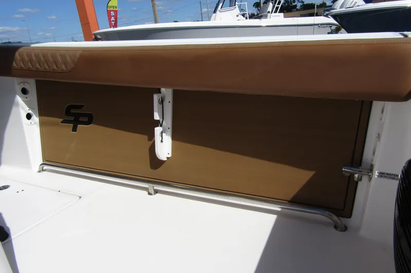  Yacht Photos Pics 2025 Sea Pro 322 Offshore boat interior with brown cushioned seating and logo detail.