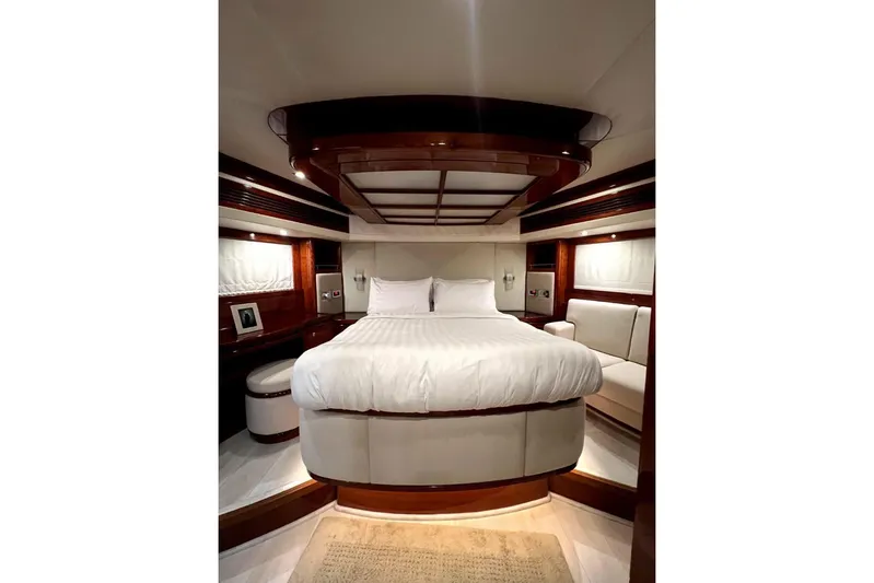  Yacht Photos Pics Luxurious bedroom interior of 2013 Gulf Craft Majesty 86 yacht with elegant wood finishes.