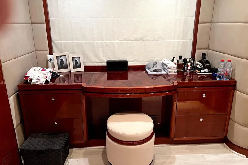  Yacht Photos Pics Luxurious wooden vanity area on 2013 Gulf Craft Majesty 86 yacht, featuring elegant decor and accessories.