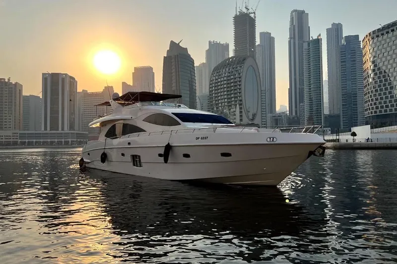  Yacht Photos Pics Luxury Gulf Craft Majesty 86 yacht on water with city skyline at sunset, 2013 model.