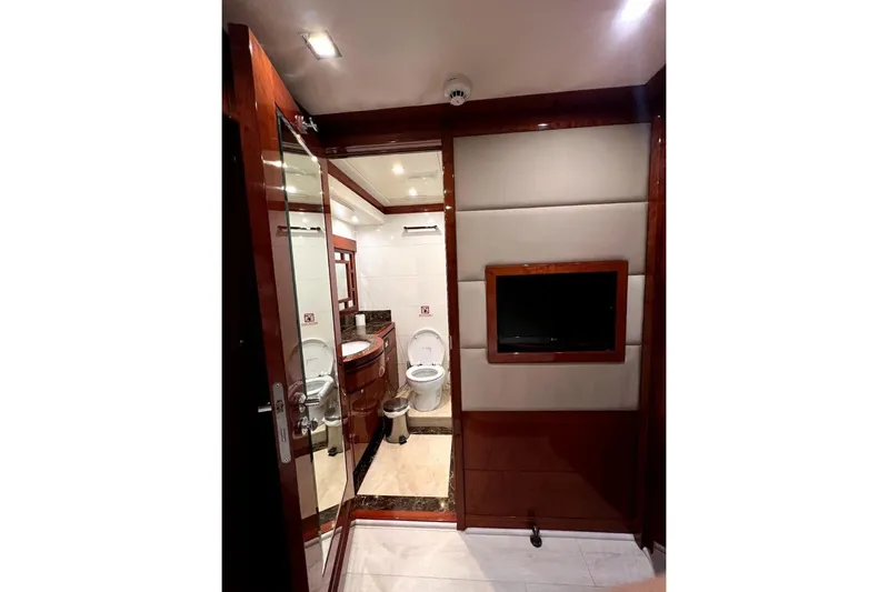  Yacht Photos Pics Luxurious bathroom interior of 2013 Gulf Craft Majesty 86 yacht, featuring elegant wood finishes.