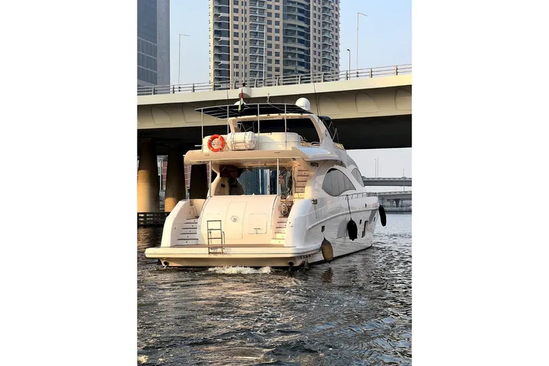  Yacht Photos Pics Luxury yacht Gulf Craft Majesty 86, 2013 model, cruising under a bridge in urban waters.