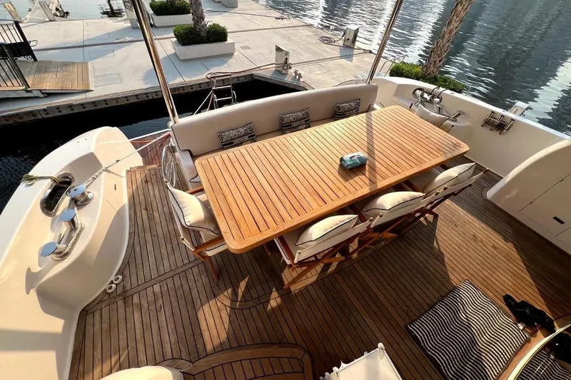  Yacht Photos Pics Luxurious 2013 Gulf Craft Majesty 86 yacht deck with elegant wooden dining area.