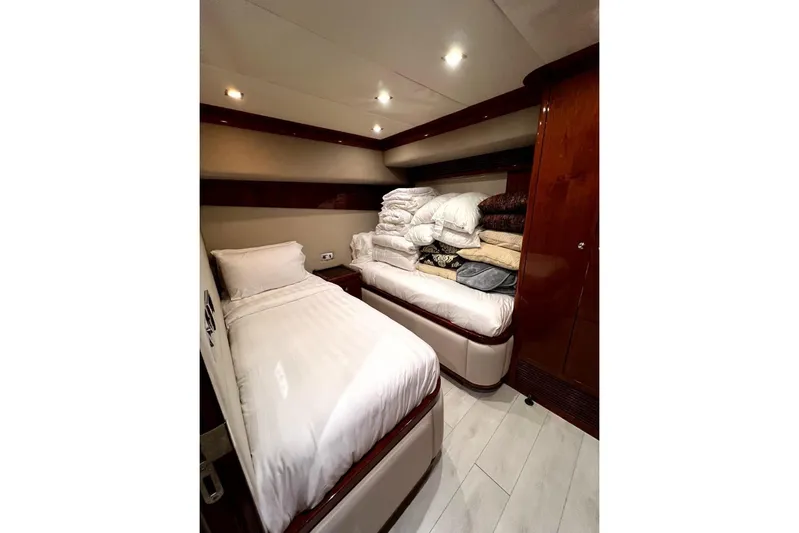  Yacht Photos Pics Luxurious cabin interior of 2013 Gulf Craft Majesty 86 yacht with twin beds and bedding.