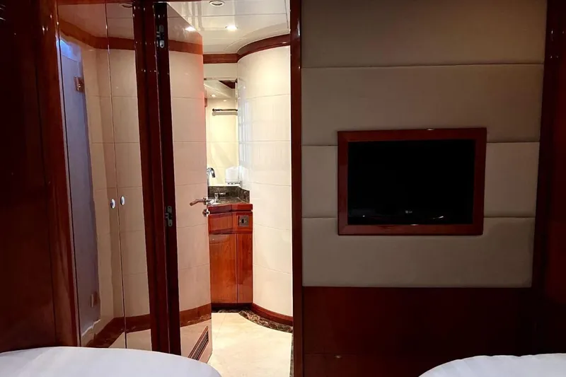  Yacht Photos Pics Luxurious interior of 2013 Gulf Craft Majesty 86 yacht with TV and ensuite bathroom.
