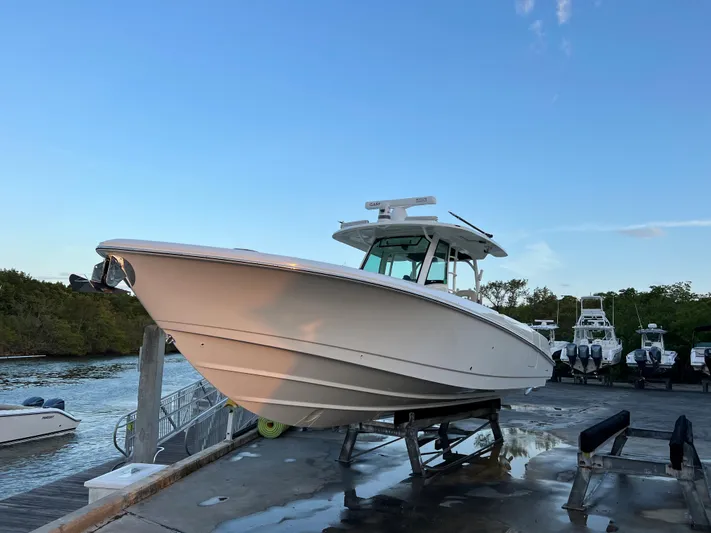  Yacht Photos Pics Boston Whaler 350 Outrage 2021 on a dock at sunset.