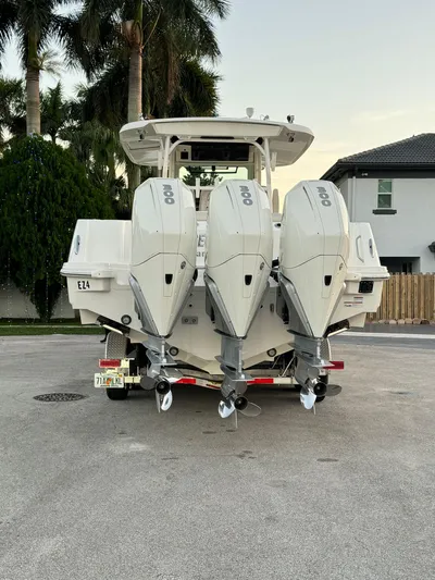  Yacht Photos Pics 2021 Boston Whaler 350 Outrage with triple outboard engines, rear view.