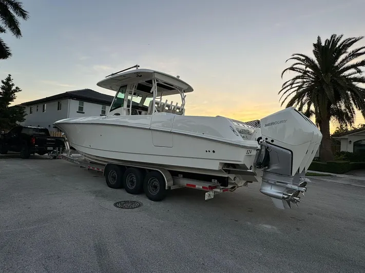  Yacht Photos Pics 2021 Boston Whaler 350 Outrage boat on a trailer at sunset.