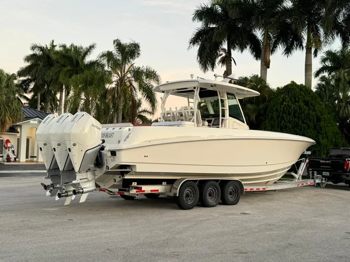  Yacht Photos Pics 2021 Boston Whaler 350 Outrage boat on a trailer with triple outboard engines.