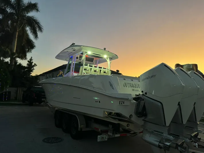  Yacht Photos Pics 2021 Boston Whaler 350 Outrage boat on trailer at sunset.