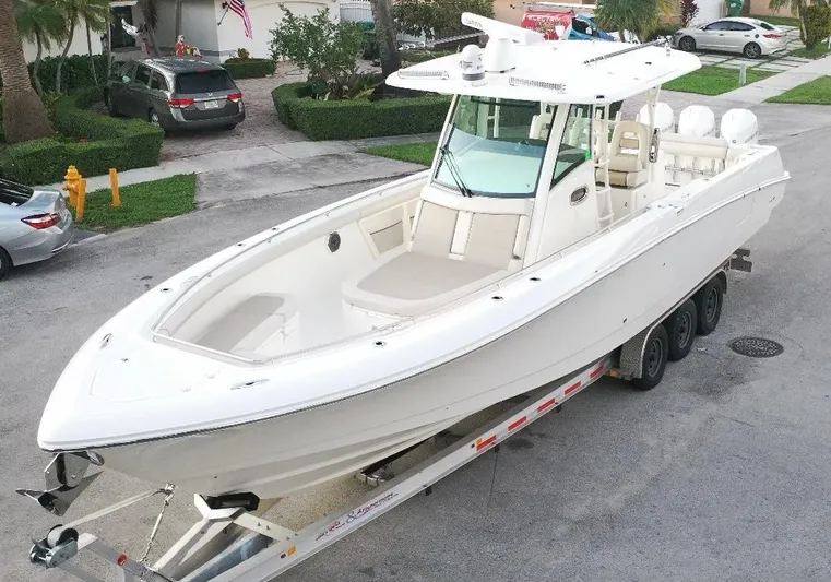  Yacht Photos Pics 2021 Boston Whaler 350 Outrage boat on a trailer in a residential area.