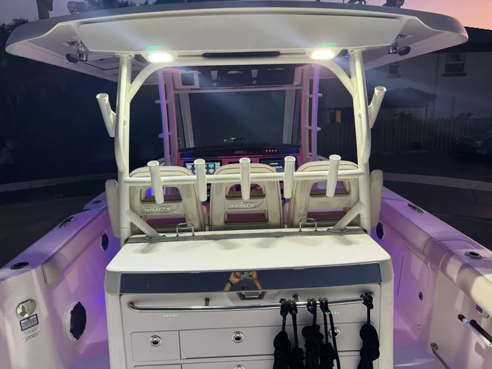  Yacht Photos Pics 2021 Boston Whaler 350 Outrage boat interior with illuminated seating and storage compartments.