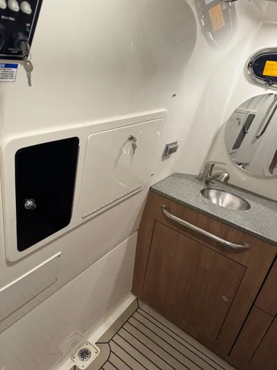  Yacht Photos Pics 2021 Boston Whaler 350 Outrage boat interior with sink and storage.