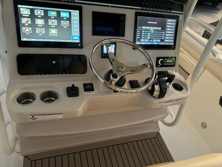  Yacht Photos Pics Boston Whaler 350 Outrage 2021 helm with advanced navigation and control systems.