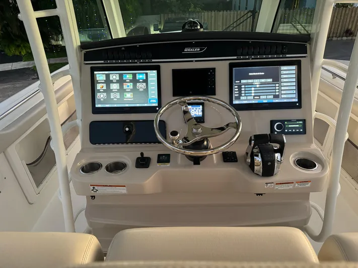  Yacht Photos Pics 2021 Boston Whaler 350 Outrage helm with advanced navigation and control systems.