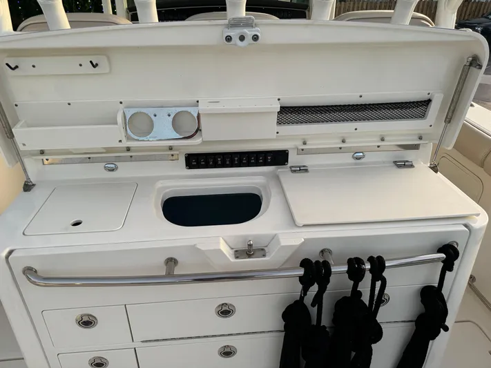  Yacht Photos Pics 2021 Boston Whaler 350 Outrage fishing station with storage compartments and rod holders.