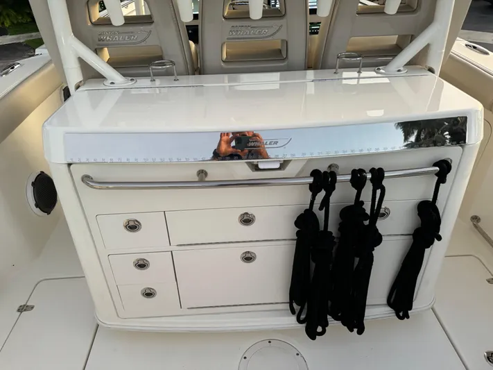  Yacht Photos Pics 2021 Boston Whaler 350 Outrage boat interior with storage drawers and rope holders.