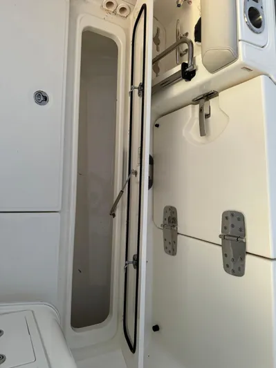  Yacht Photos Pics 2021 Boston Whaler 350 Outrage storage compartment and seating area.