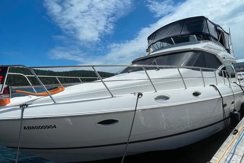  Yacht Photos Pics 2001 Cruisers Yachts 5000 Pilothouse docked under a clear blue sky.