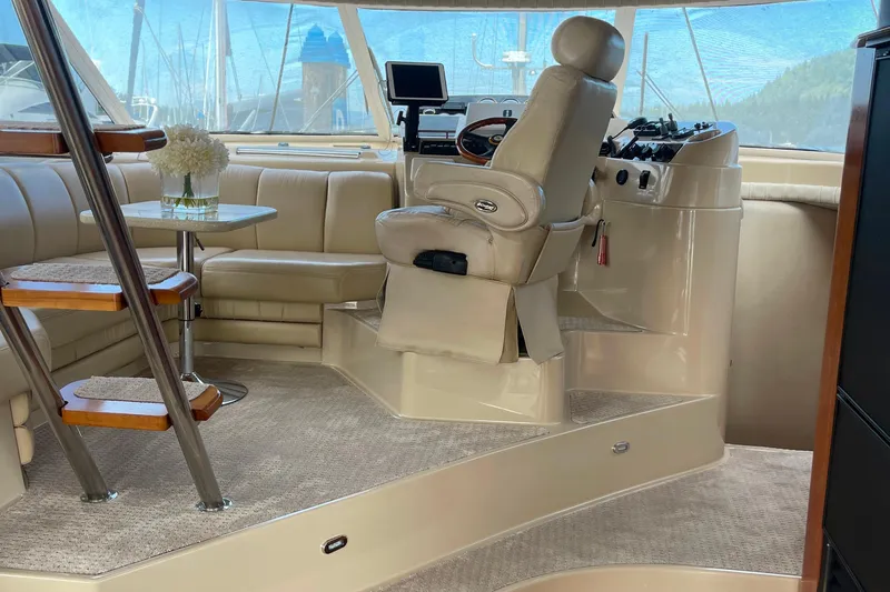  Yacht Photos Pics Luxurious interior of 2001 Cruisers Yachts 5000 Pilothouse with helm and seating area.